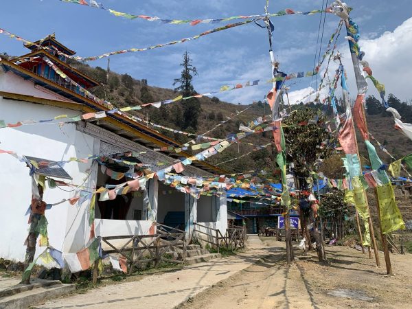 Buddhist monastery in Chandanbari with colorful prayer flags