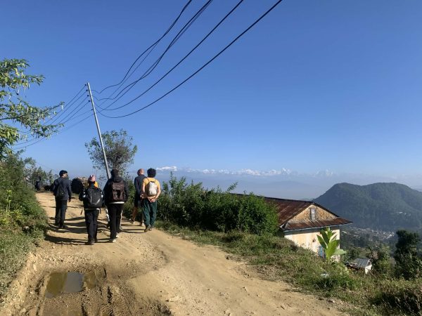 Walking through villages on background Himalayan ranges.